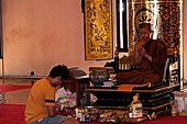 Chiang Mai - The Wat Chedi Luang, inside the viharn, young Buddhist monk gives their blessing.